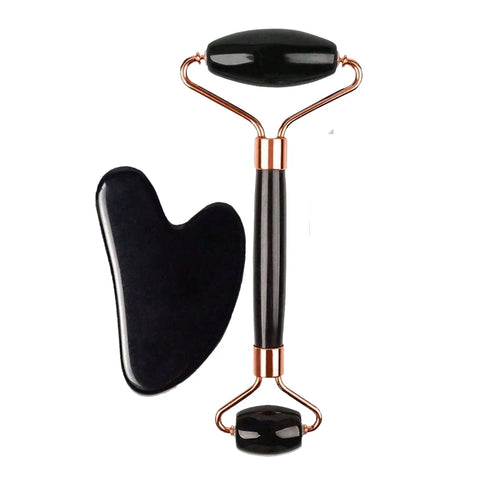 Black facial roller and gua sha tool on a white background